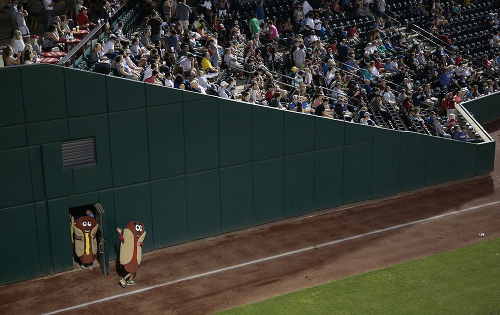 SPSports Feature - HM - The Sugardale Hot Dog mascots enter the stadium for their race in the middle of the seventh inning during an International League baseball game between the Columbus Clippers and the Louisville Bats on at Huntington Park in Columbus. (Joshua A. Bickel / The Columbus Dispatch)