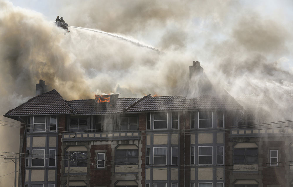    Spot News - 2nd place - Firefighters work to put out  a blaze at an apartment building on 16th Street in Toledo. (Jeremy Wadsworth / The Blade)