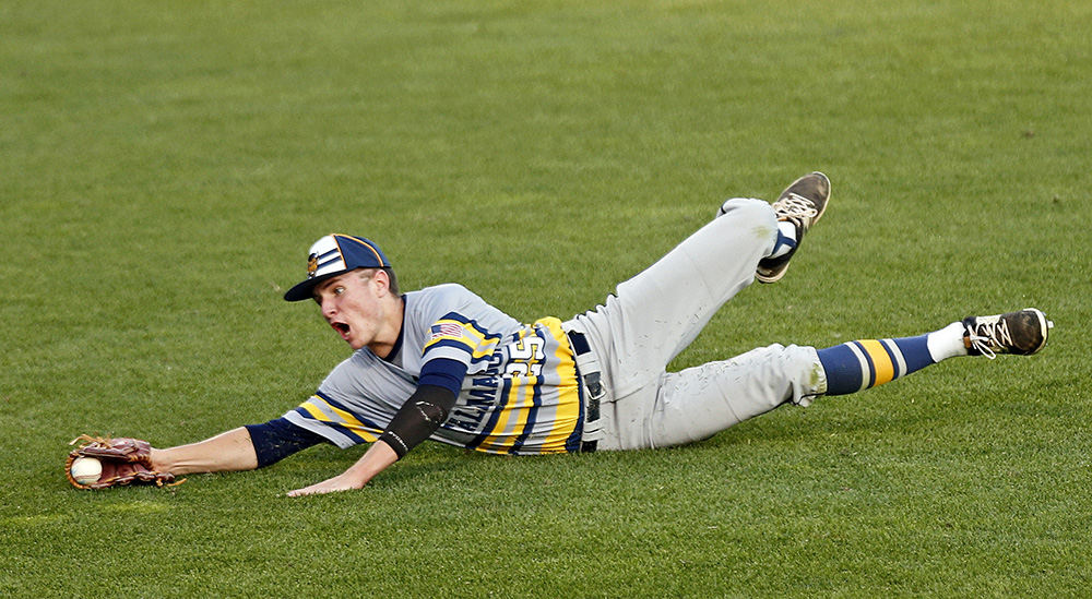 Sports - 3rd place - Sam Seeker of Tallmadge dives for a fly ball in left field during an Division II state semi-final game against Maumee at Huntington Park in Columbus. (Barbara J. Perenic / The Columbus Dispatch)