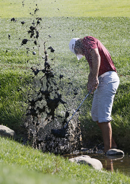 SStory - 2nd place - Aaron Baddeley makes a mess as he hits out of the creek on the 17th hole during the first round of the Memorial Tournament at Muirfield Village Golf Club. (Adam Cairns / The Columbus Dispatch)