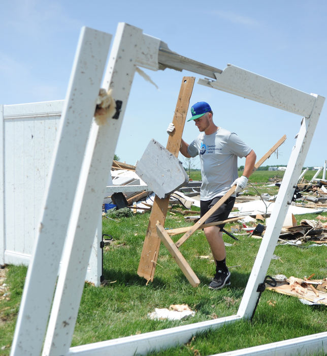 General News - 1st placeGrand Lake Mariners' Donnie Stone help clean up debris from the Memorial Day tornado at 1215 Fairground Road in Celina. (Daniel Melograna/The Daily Standard)