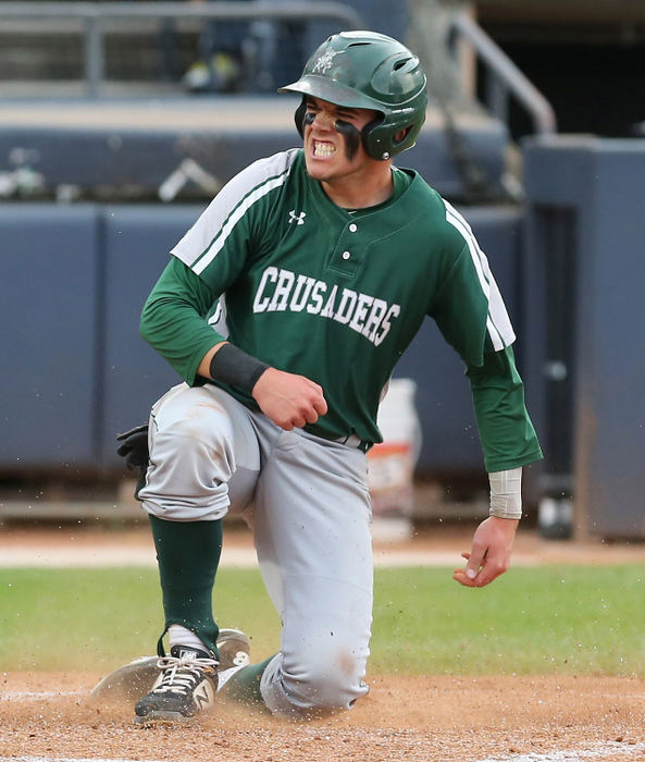 Sports Feature - HMCentral Catholic’s Christian Turner reacts after scoring during the second inning of their Div III state semifinal game against Ridgewood at Canal Park in Akron. (Scott Heckel/The Canton Repository)