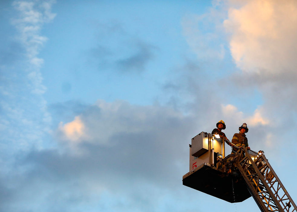 Spot News - 2nd placeToledo Fire & Rescue look at the sunset while responding to a house fire on Magnolia Street in Toledo. The house was abandoned and no one was injured. (Rebecca Benson/The Blade)