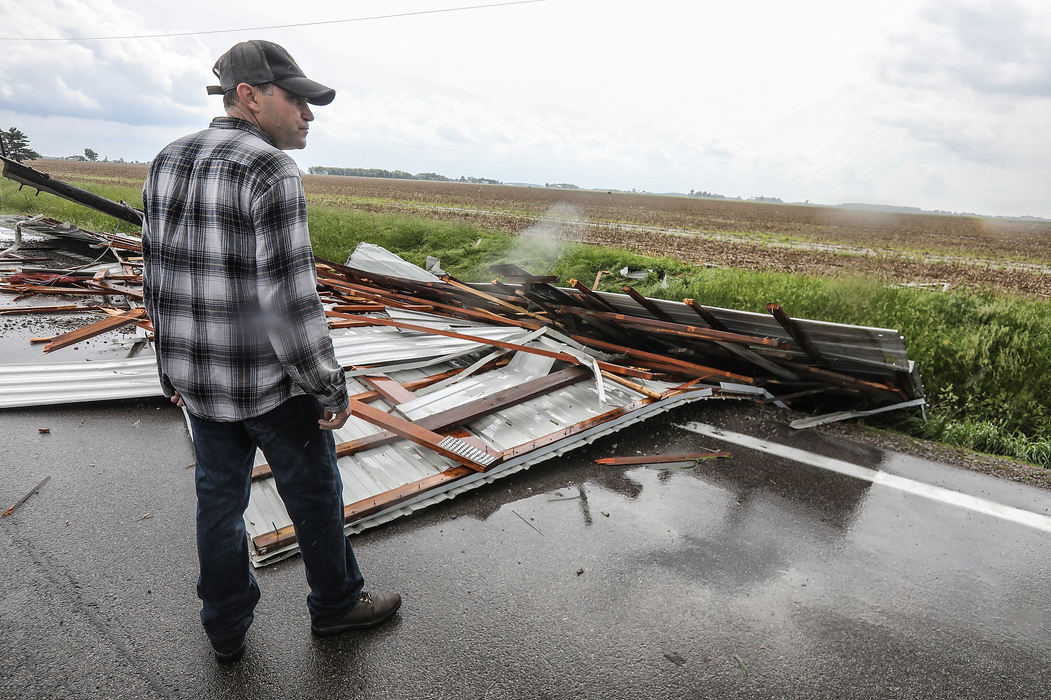 Spot News - HMA man surveys part of a barn that was damaged by a tornado on State Route 65 near Westhope in Henry County, Ohio. (Jeremy Wadsworth/The Blade)