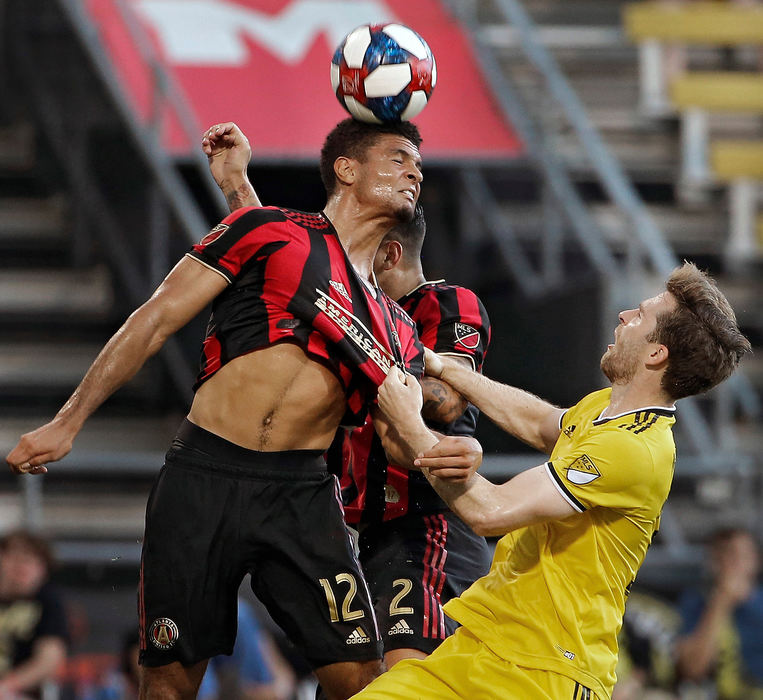 Sports - 2nd placeColumbus Crew SC forward Patrick Mullins (32) pulls the shirt of Atlanta United defender Miles Robinson (12) on a header during the first half during an U.S. Open Cup game at MAPFRE Stadium in Columbus.(Kyle Robertson/The Columbus Dispatch)