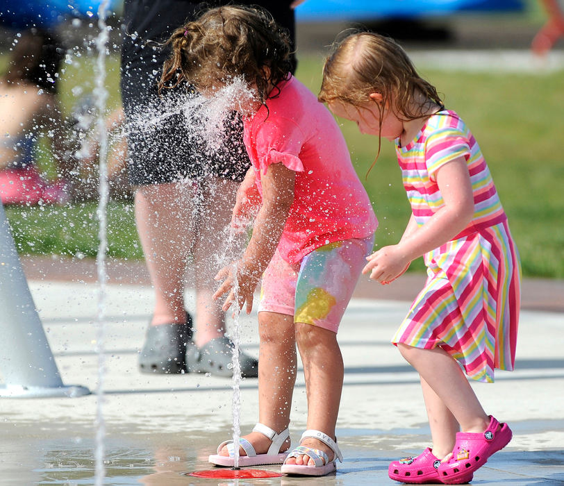 Feature - 2nd place - Elsie Knous, 2, gets a face full of water as she and her cousin, Elly Dillinger, 3, play in the splash pad in the Bryson Park District along Lake Shore Drive in Celina. (Daniel Melograna / The Daily Standard)