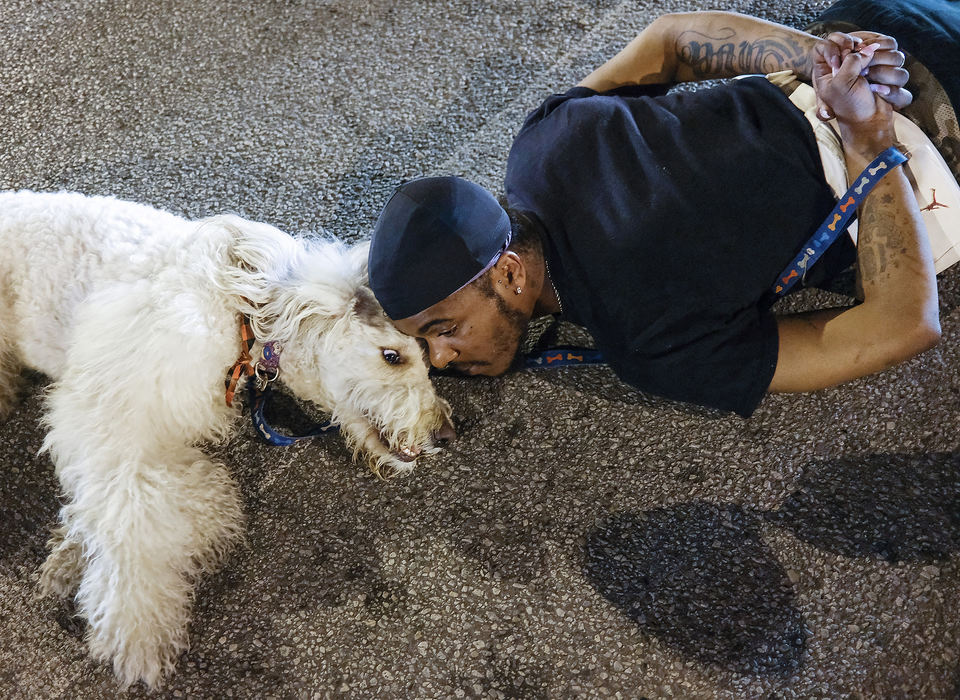 General News - 1st place - Black Lives Matters protestors Darius Smith lies in the middle of the street at the intersection of Sylvania Avenue and Jackman Road in Toledo with his dog to protest the killing of George Floyd by a police officer in Minneapolis. (Jeremy Wadsworth / The Blade)