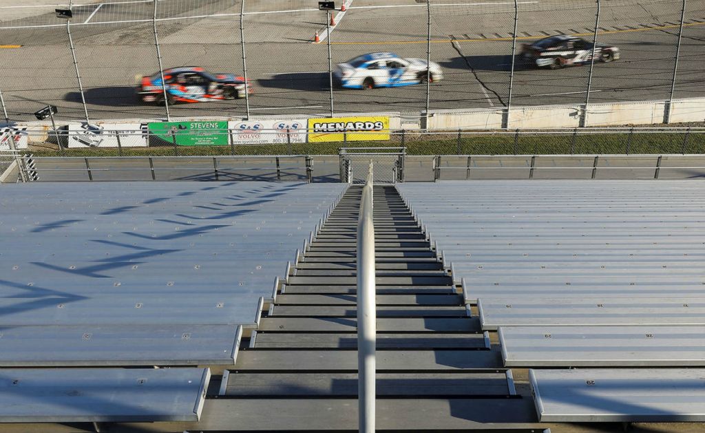 Sports Feature - 2nd place - Cars go by an empty grandstand during the Herr's Potato Chips 200 ARCA race at the Toledo Speedway. Spectators were not allowed at this race due to coronavirus concerns. (Kurt Steiss / The Blade)