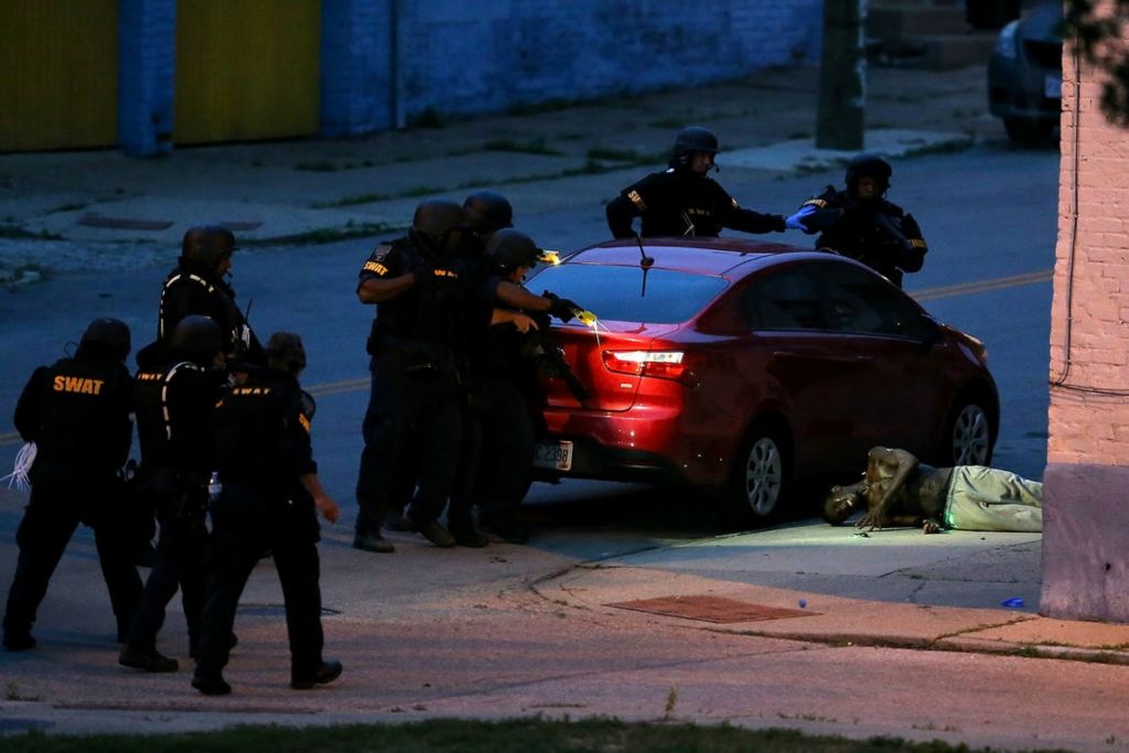 Spot News - 1st place - Cincinnati police subdue Kaleb Moore, 24, by projectile stun gun after a four-hour standoff Freeman Avenue in the West End neighborhood of Cincinnati. Police were first alerted of Moore, who has history of bipolar disorder and schizophrenia at about 5 p.m. and he was Tased at least once before he was taken into custody. Moore was taken to University of Cincinnati Medical Center for evaluation.  (Kareem Elgazzar / The Cincinnati Enquirer)