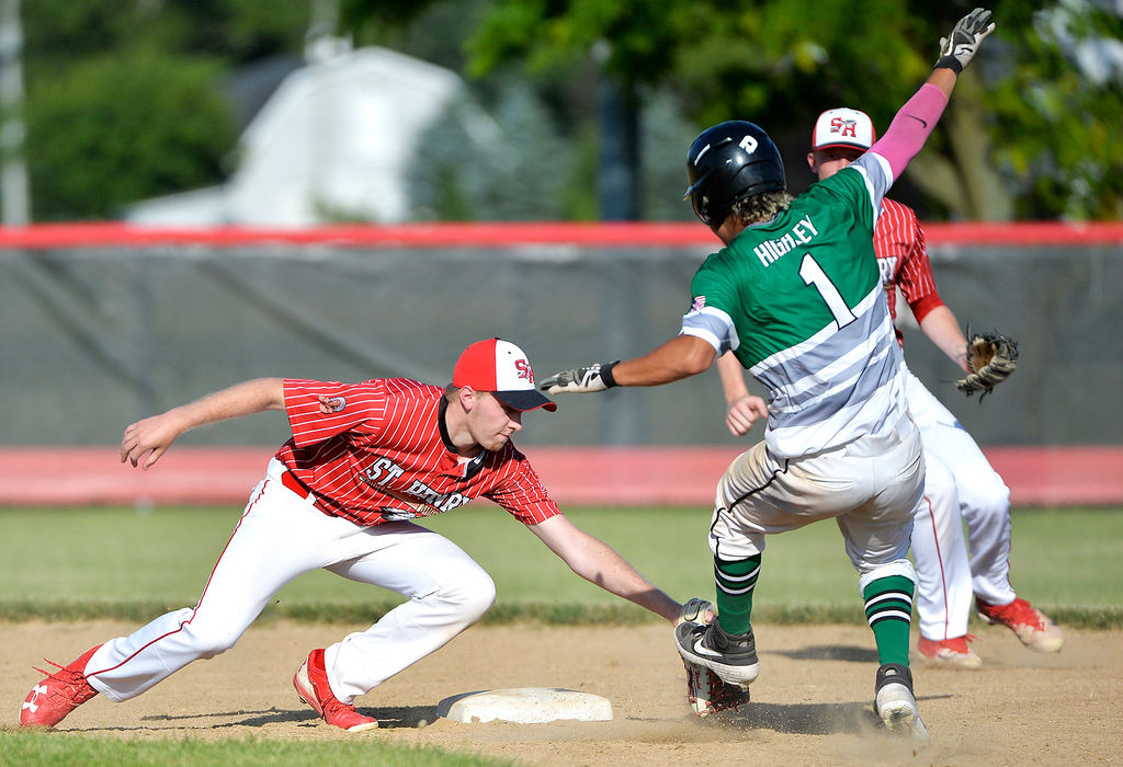 Sports - 3rd place - St. Henry’s Isaac Wendel (22) tags Celina’s Caden Highley out at second base in the 1st inning at the Wally Post Athletic Complex in St. Henry. (Daniel Melograna / The Daily Standard)