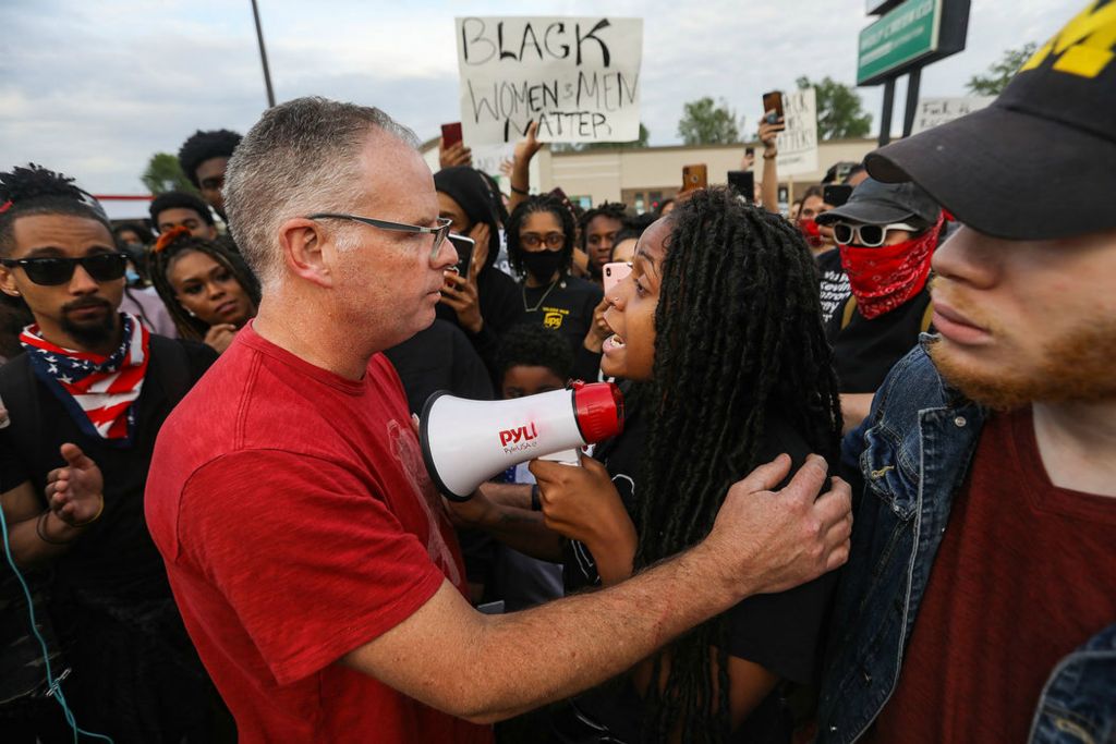 Story - HM - Toledo Police Chief George Kral listens to Mariah Coleman during a protest on South Reynolds Road in Toledo. (Rebecca Benson / The Blade)