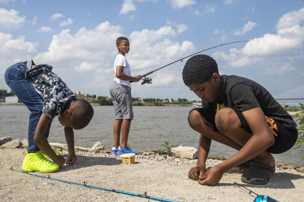 Feature - 1st place - Chase Darrington, who is celebrating his 7th birthday (left) DeMarco Carter, 11, (center) and Kavet Johnson, 12, fish together at Glass City Metropark in Toledo. (Rebecca Benson / The Blade)