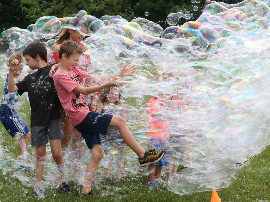 Feature - 2nd place - Children brace for a surge of bubbles during Freedom Fest at Boettler Park in Green. Gary Pearlman, better known at "Dr. U.R. Awesome," provided the bubbles for the event. (Scott Heckel / The Canton Repository)