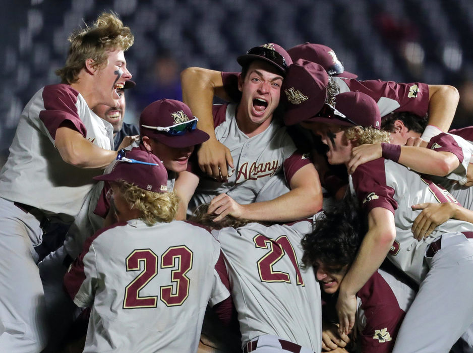 Sports Feature - 3rd place - New Albany players celebrate after winning the OHSAA Division I state championship with a 6-5 victory against Cincinnati Elder at Canal Park in Akron. (Jeff Lange / Akron Beacon Journal)