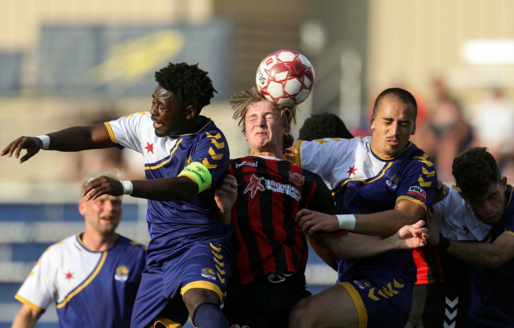 Sports - 1st place - Toledo’s Nathan Masters (center) hits a header during a Toledo Villa FC game against South Bend Lions FC in USL League Two competition at the University of Toledo’s Paul Hotmer Field. (Kurt Steiss / The Blade)