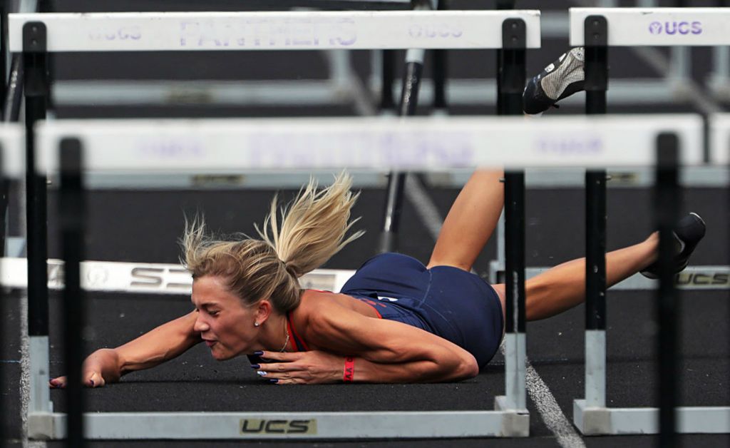 Sports - 2nd place - Galion’s Samantha Comer tumbles to the track as she trips over a hurdle in the 100 meter hurdles event during the Division II OHSAA State Track and Field Meet at Pickerington High School North. (Jeff Lange / Akron Beacon Journal)