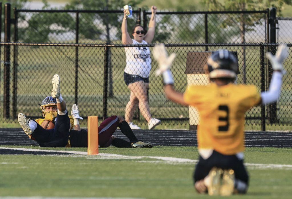 Sports - HM - Gold Team wide receiver Brandon Taylor (Archbold), left, scores a touchdown against the Black Team during the Northwest Ohio Regional All-Star Football Game at  Steinecker Stadium in Perrysburg.   (Jeremy Wadsworth / The Blade)