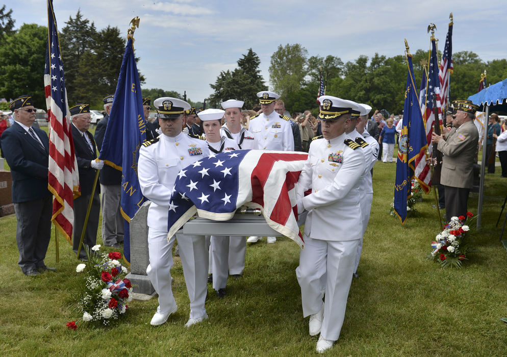 Story - 1st place - The Navy Funeral Honor Guard carries the casket of SF3c Robert E. Bailey to his final resting place beside his brother and parents at Swamp College Cemetary in Celina. Bailey died in 1941 while serving aboard the USS Oklahoma at Pearl Harbor. (Daniel Melograna / The Daily Standard)