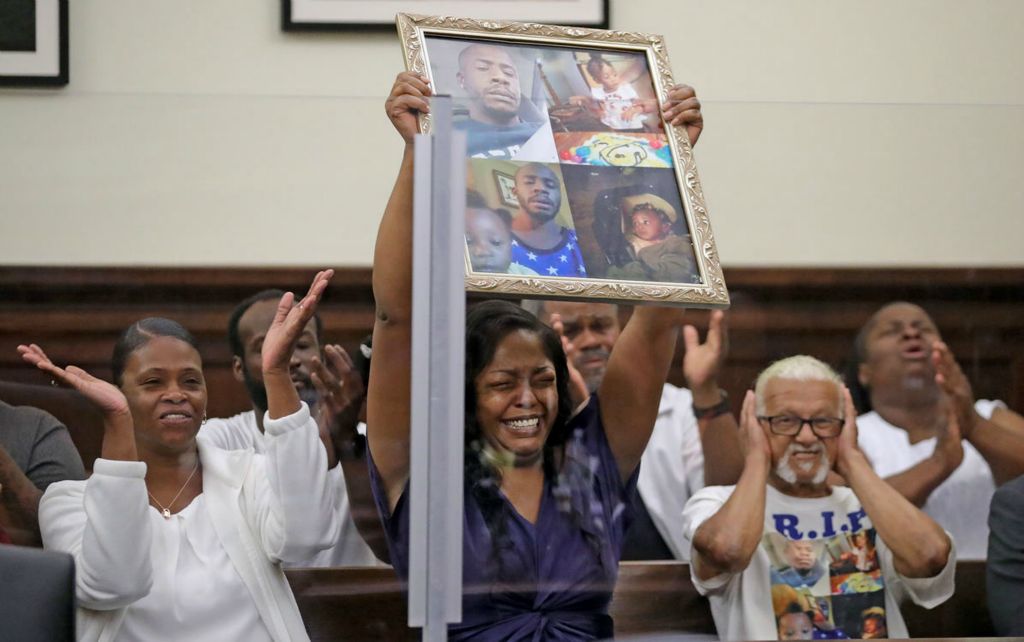 General News - 1st place - Carmon Lee (center) and other family members of Horace Lee and Azariah Tucker celebrate as Shawn Allen is sentenced to 63 years to life in prison for the hit-and-run murders of the Akron man and his 21-month-old daughter in the courtroom of Summit County Common Pleas Court Judge Susan Baker Ross in Akron. (Jeff Lange / Akron Beacon Journal)