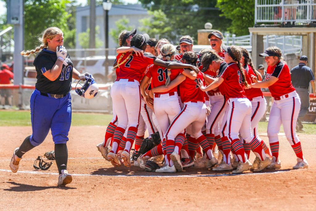 Sports Feature - 3rd place - Springfield’s Taylee Long (left) jogs off the field as Lakota West celebrates its OHSAA Division I state softball championship at Firestone Stadium in Akron. (Isaac Ritchey / The Blade)