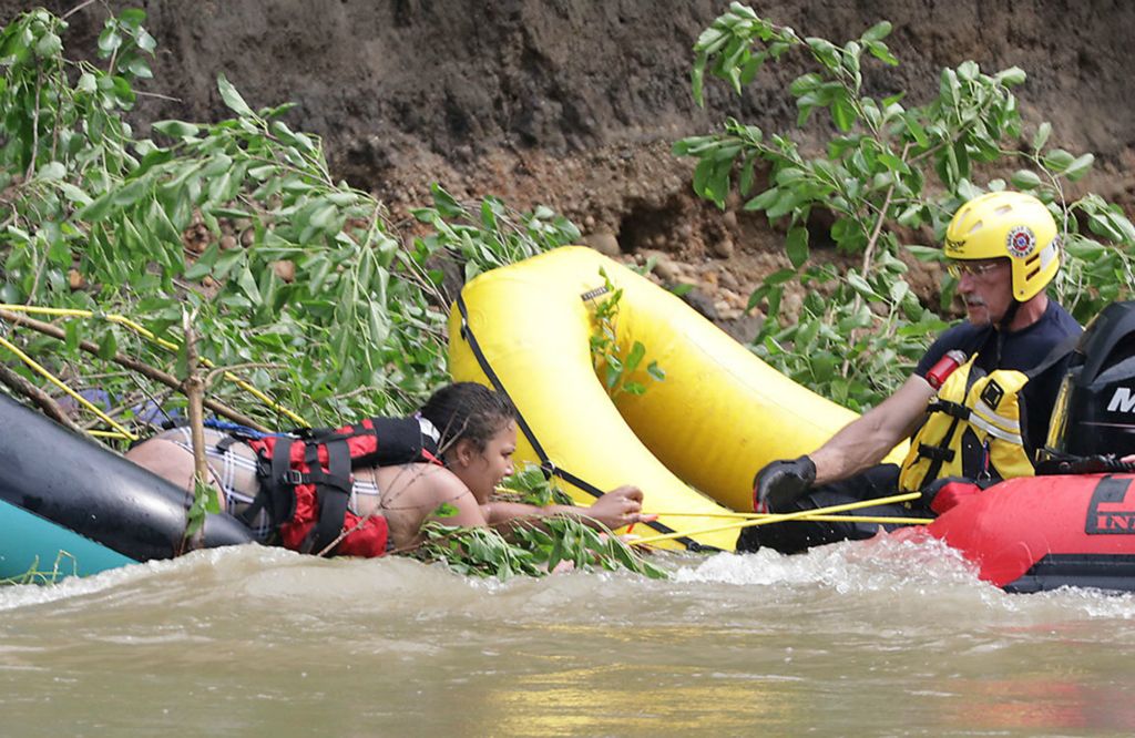 Spot News - 2nd place - Firefighters from the German Township Fire Department rescue one of four people who were trapped in the middle of the Mad River. The people were tubing on the swollen river above Springfield when they got stuck on a tree that had fallen in the river. All four people were rescued safely.  (Bill Lackey / Springfield News-Sun)