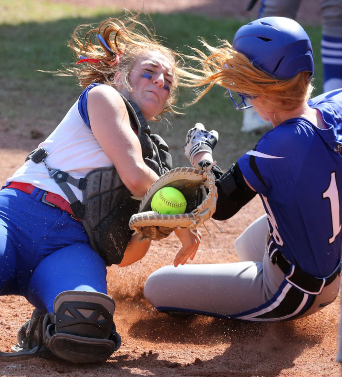 Sports - 3rd place - Miriam Peterson (left) of Tuslaw collides with and tags out Rachael Haak, 18, of Miami East at home plate during their Div III state semifinal game at Firestone Stadium in Akron. (Scott Heckel / The Canton Repository)