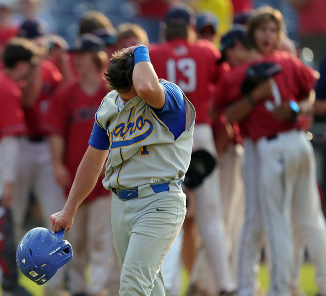 Sports Feature - 1st place - Ontario pitcher Peyton Dzugan hides his face in his jersey as the Kenston Bombers celebrate winning the OHSAA Division II state championship baseball game at Canal Park in Akron. (Jeff Lange / Akron Beacon Journal)