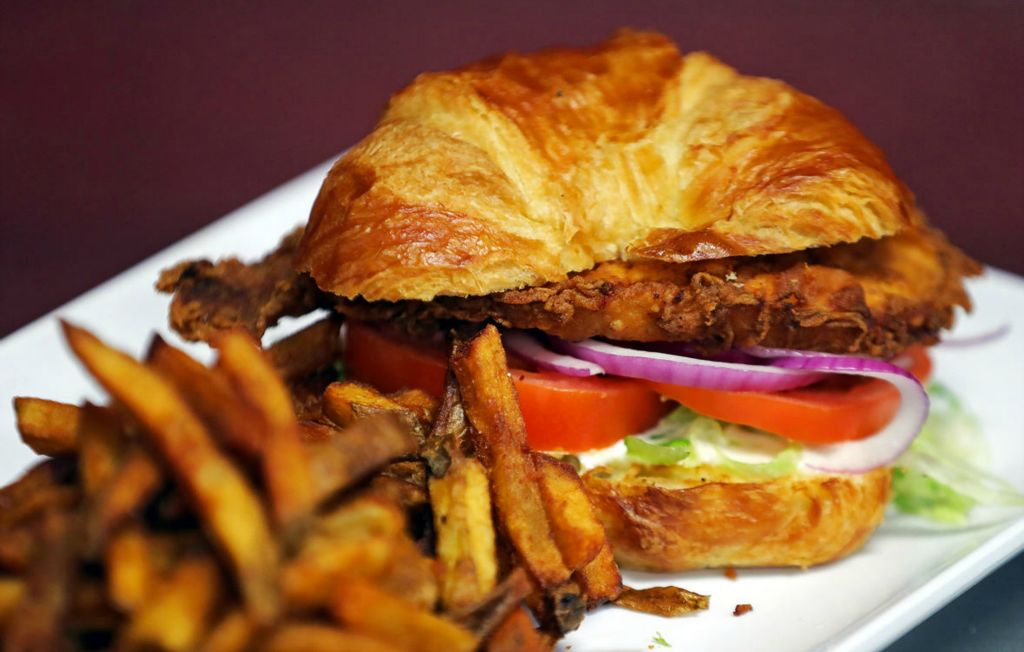 Illustration - 2nd place - The French chic, a deep friend chicken breast, with lettuce, tomato, pickle, red onion on a croissant, from The Eye Opener, in Akron. (Jeff Lange / Akron Beacon Journal)