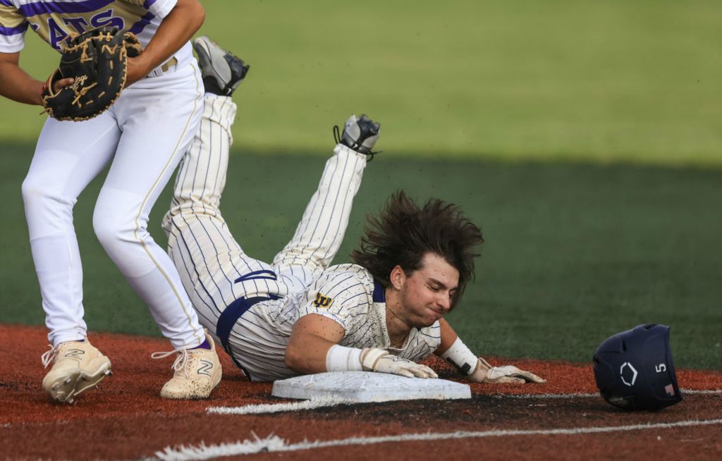 Sports Feature - 3rd place - Whiteford’s Mason VanBrandt loses his helmet as he dives back to first base to avoid the tag during the MHSAA Division 3 regional baseball semifinal at Siena Heights University in Adrian, Mich. Whiteford defeated Onsted, 5-1. (Rebecca Benson / The Blade)