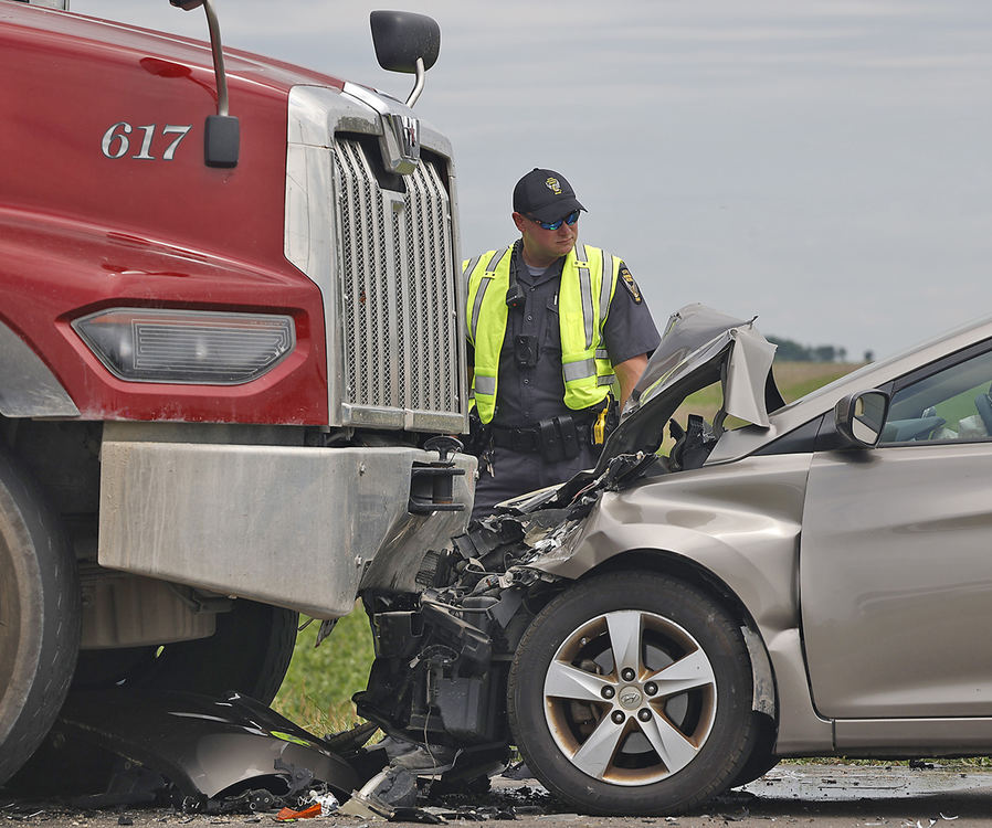 Spot News - 1st place - The driver of a car traveling north on South Charleston Pike was transported by CareFlight after he crashed into a dump truck traveling south. The crash occurred in a construction area, where the road was closed down to one lane and flaggers were in place to control traffic. According to members of the construction crew, the truck was given the right-of-way and the car failed to stop. The driver of the dump truck was not injured.  (Bill Lackey / Springfield News-Sun)