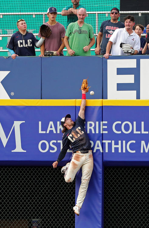 Sports - 3rd place - Cleveland Guardians shortstop Daniel Schneemann (10) barely misses a home run ball hit by Seattle Mariners shortstop J.P. Crawford (3) during the third inning of agame at Progressive Field, in Cleveland. (Jeff Lange / Akron Beacon Journal)