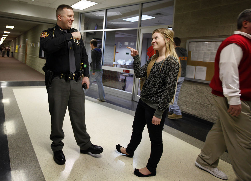 General News - 1st place - Delaware County Sheriff's deputy Mark Kern is the school resource officer for the Big Walnut School district. Here he talks to junior Emily Fiasconi, at Big Walnut High School. Fiasconi credits deputy Kern for his positive influence on her life and the choices she has made outside of school. She has also chosen him to present her with her high school diploma when she graduates next year. (Jonathan Quilter / The Columbus Dispatch)