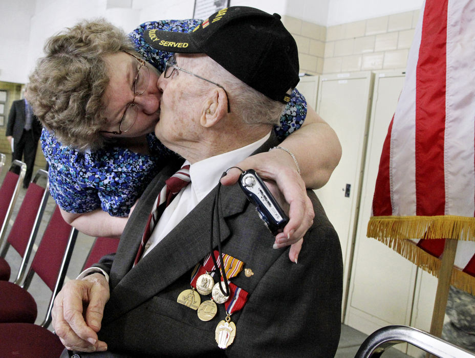 General News - 3rd place - Joyce Smith gives her father Elton Hietman a kiss after a ceremony during which the 88-year-old World War II veteran from Xenia was presented with five medals he never received from his service in the United State Army. (Barbara J. Perenic / Springfield News-Sun)