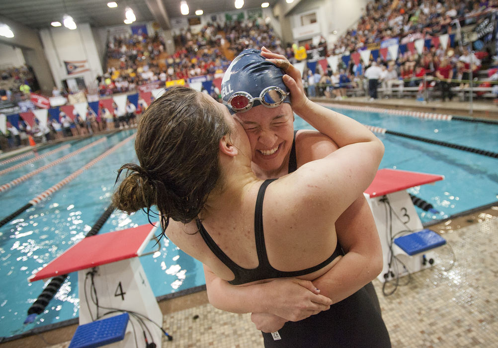 Sports Feature - 1st placeHartley's Andrea Cottrell gets a hug from Academy's India Sherman after winning the 100-yard breaststroke during finals of the Div. II state swim meet at CT Branin Natatorium in Canton.  (Adam Cairns / ThisWeek Newspapers)