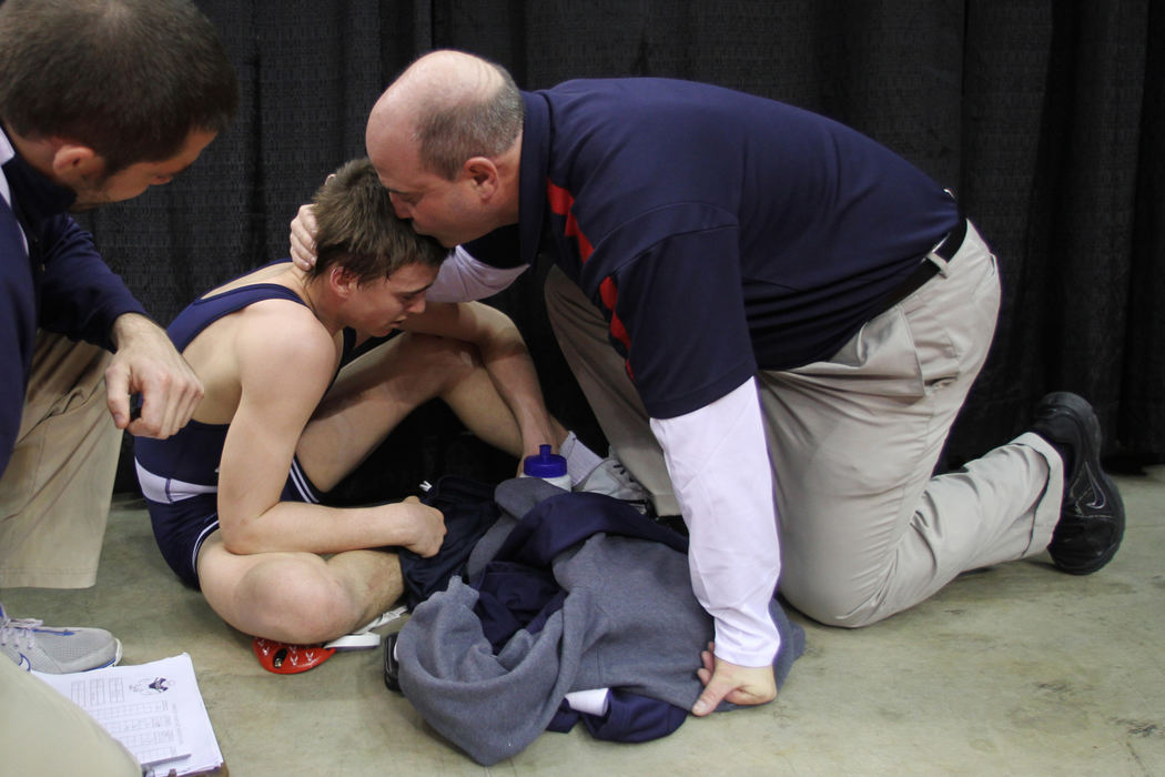 Sports Feature - 2nd placeGrant Rathburn consoles his son Grant after Grant lost his Division III 126-pound state semi final bout.  (Neal C. Lauron / The Columbus Dispatch)