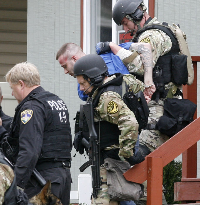 Spot News - 3rd placeJerry Rohr is taken into custody by Canton police after a standoff on Broad Ave NW  in Canton. Rohr was accused of shooting a man in a local barbershop the night before. Authorities surrounded the house and eventually had to break in the door to extricate Rohr by force. He was eventually taken to a local hospital for treatment of injuries he suffered in the arrest. (Scott Heckel / The (Canton) Repository)