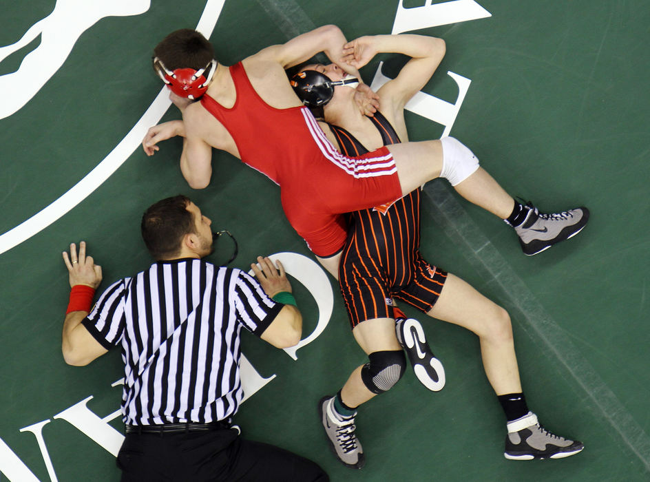 Sports - 2nd placeAustin Assad of Brecksville (center) wrestles Brandon Tucker of Loveland during their Division I, 106-pound state wrestling match at Value City Arena. Assad won his bout. (Neal C. Lauron / The Columbus Dispatch)