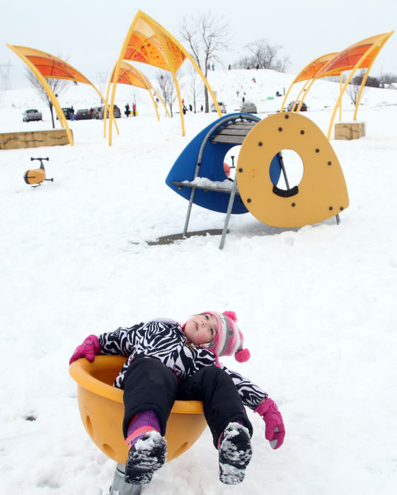 Feature - 2nd placeFive year-old Olyvia Piper decides to play on the playground at Fryer Park rather than joining her older brother Cole Matthews on the sled hill.   (Lorrie Cecil / ThisWeek Newspapers)