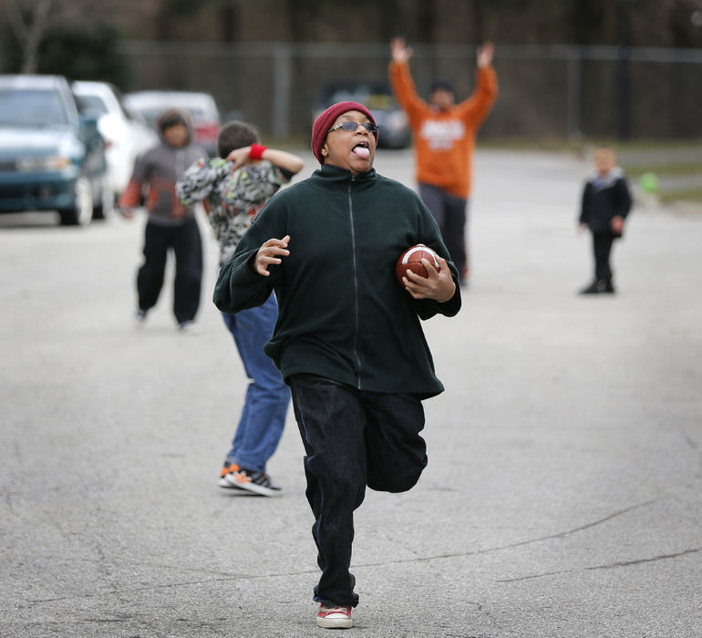 Feature - 3rd placeZion Fitzgerald plays two-hand touch football with his brother and neighborhood friends on their dead-end street in Reynoldsburg. (Jonathan Quilter / The Columbus Dispatch)