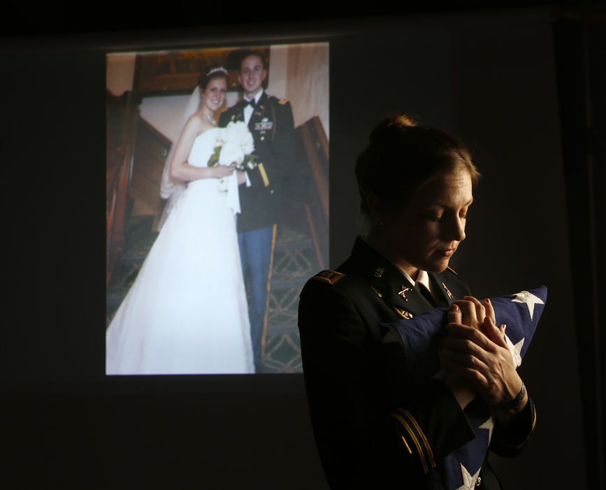 Portrait - 1st placeOhio State law student Jenna Grassbaugh holds the flag that draped her husband's coffin after he was killed in Iraq in 2007, 10 months after they were married. She is using the life insurance money to start a clinic to help returning veterans with legal and other services. (Jonathan Quilter / The Columbus Dispatch)