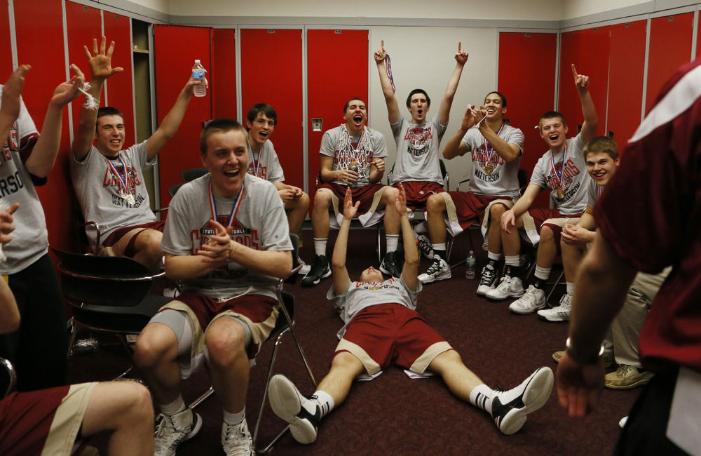 Sports Feature - 1st placeBishop Watterson players celebrate their championship over St. Vincent St. Mary as coaches and fans begin to appear in the locker room after their championship game at Value City Arena (Eric Albrecht / The Columbus Dispatch)