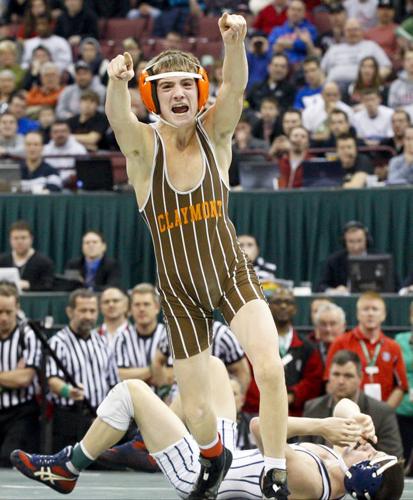 Sports Feature - 3rd placeTyler Warner, of Uhrichsville Claymont, reacts to winning a state title at 106 lbs. over Seth Beard, of Napoleon, during the Ohio high school wrestling championships. (Barbara J. Perenic / Springfield News-Sun)