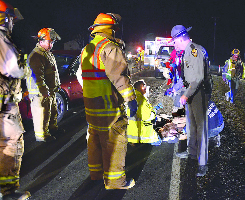 Spot News - 1st placeWinona Fire department and Damascus Fire/EMS tend to 41-year-old Tracie Taylor, of Salem, following a head-on crash on Depot Road. Taylor, driving a red Ford Taurus, was southbound and went left-of-center, striking Amanda Gutierrez, who was driving a silver Chrysler Voyager north on Depot Road.  (Patricia Schaeffer / The (Lisbon) Morning Journal)