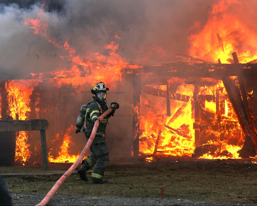 Spot News - 3rd placeA Rome firefighter looks back as he prepares to battle a barn fire Monday at 3452 Mill Road in Cherry Valley Township. Andover and Dorset also responded to the scene. (William A. West / West News Service)