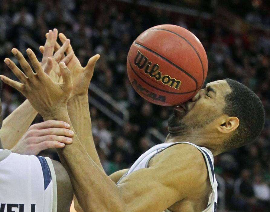 Sports - 1st placeAkron big man Zeke Marshall takes a loose ball in the face during the second half against Ohio in the Mid-American Conference Championship game at Quicken Loans Arena. The Zips won the game 65-46.  (Phil Masturzo / Akron Beacon Journal)