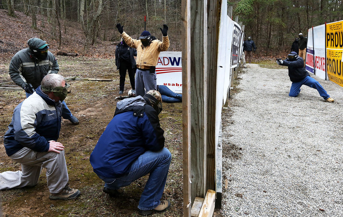 Story - 1st placeStudents are held at Air Soft gunpoint during a role playing exercise at the Tactical Defense Institute Headquarters in West Union. The Buckeye Firearm Foundation paid $30,000.00 to to host a an active shooter training session for 24 Ohio school workers. During the sessions school workers learned how to shoot a firearm, gun safety guidelines, first aid in the event of a shooting and role play on how to subdue an attacker. In this scenario, students were asked to re-enact various scenarios that related to real-life school shootings. Air Soft guns were used in place of real weapons.  (Brooke LaValley / The Columbus Dispatch)