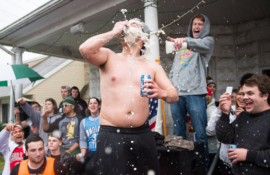 General News - 3rd place - Matt Wiencek shotguns a beer on the front steps of a Palmer Street residence in Athens.  (Isaac Hale / Ohio University)