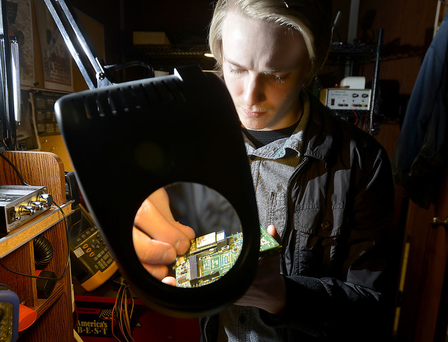 Portrait - HM - Cody Wick works on a project in the IT department at Ohio Stamping in Springfield. Wick was a former student in the Springfield High School internship program and now works for the company he interned for.  (Bill Lackey / Springfield News-Sun)