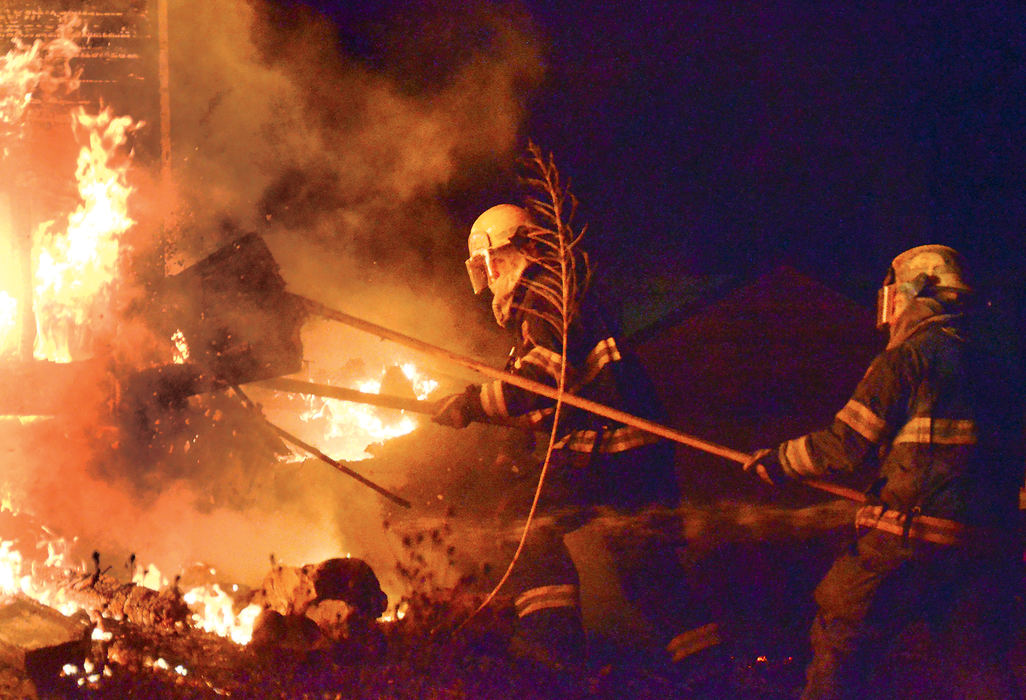 Spot News - 2nd place - Salineville firefighters along with men from Franklin Township kept flames from spreading after the decision was made to let a fire at a vacant Water Street house burn. Salineville Chief Jeff Lewis said  his department was called to a fire at the same location about a year ago,and according to Lewis the utilities to the home had been disconnected which he said places the cause of the fire under suspicion. (Patricia Schaeffer / The (Lisbon) Morning Journal)