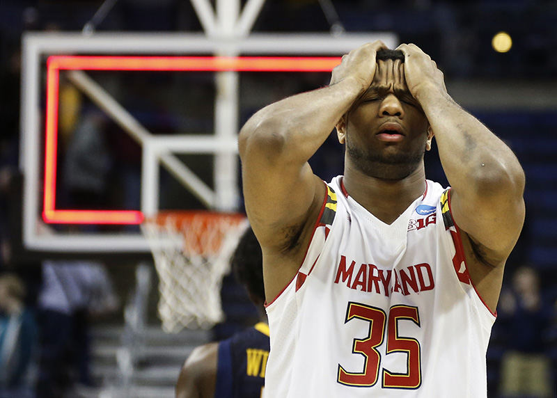 Sports Feature - 1st place - Damonte Dodd (35) of the Maryland Terrapins reacts as the buzzer sounds to a 69-59 loss to the West Virginia Mountaineers in a third-round NCAA tournament game at Nationwide Arena in Columbus. (Barbara J. Perenic / The Columbus Dispatch)